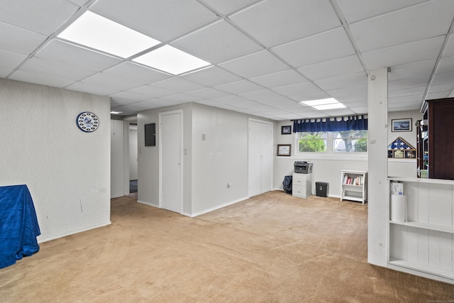 below grade area featuring a paneled ceiling and carpet floors