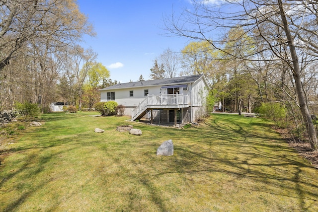 back of property with stairway, a deck, and a yard