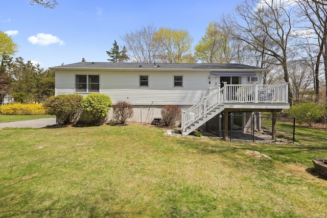 rear view of house featuring stairway, a deck, a yard, and a wall unit AC