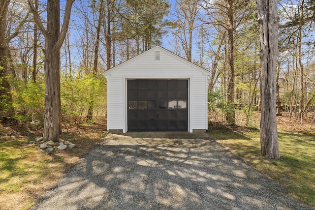 detached garage featuring aphalt driveway