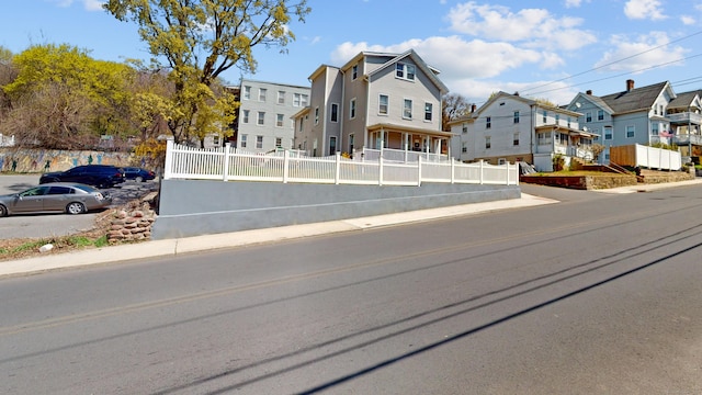 view of street featuring a residential view, sidewalks, and curbs