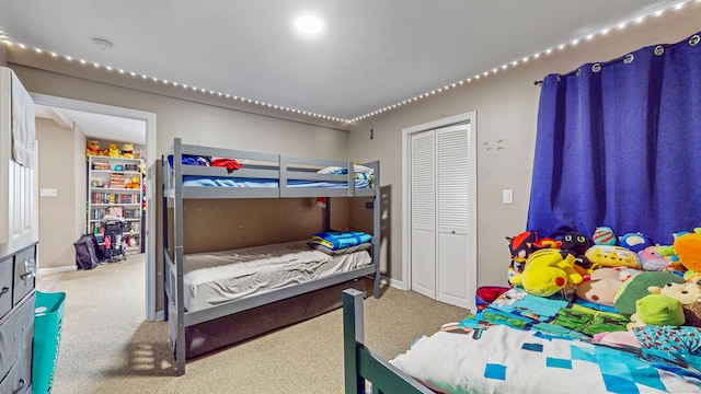 bedroom featuring a closet, carpet flooring, and baseboards