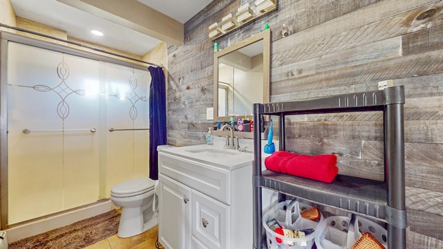 full bath with a stall shower, toilet, and vanity