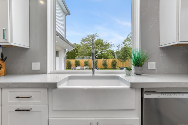 60 Eleanor Ter, Fairfield, CT 06824 - kitchen with dishwasher, a sink, decorative backsplash, and white cabinets