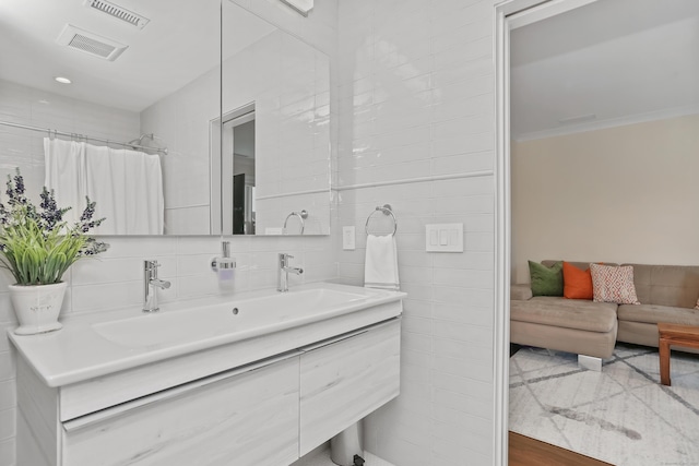 60 Eleanor Ter, Fairfield, CT 06824 - bathroom with tile walls, vanity, ornamental molding, a shower with shower curtain, and tasteful backsplash