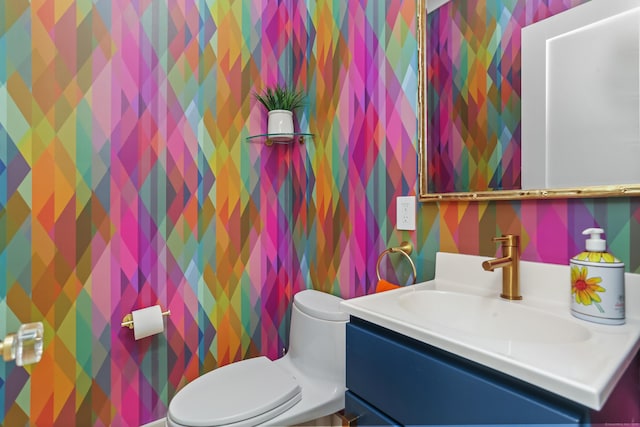 60 Eleanor Ter, Fairfield, CT 06824 - half bathroom featuring wallpapered walls, vanity, and toilet