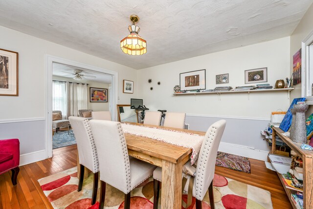 dining area featuring wood finished floors and baseboards