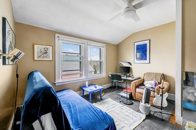 interior space with ceiling fan, lofted ceiling, and baseboards