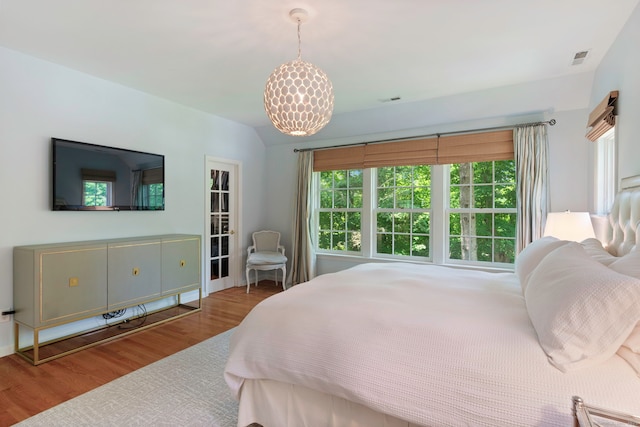 bedroom with visible vents and wood finished floors