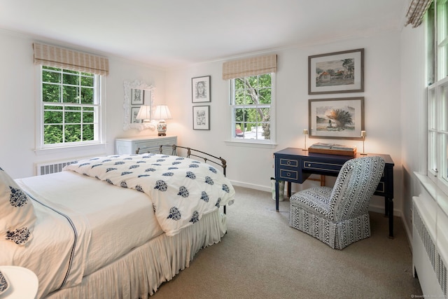 carpeted bedroom with baseboards, ornamental molding, and radiator