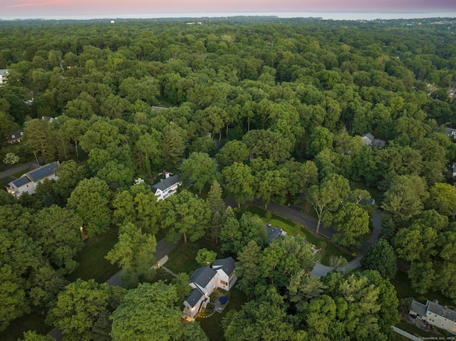 bird's eye view featuring a wooded view