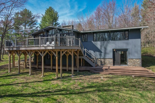187 Sherbrook Dr, Goshen, CT 06756 - rear view of house featuring stone siding, a wooden deck, and a lawn
