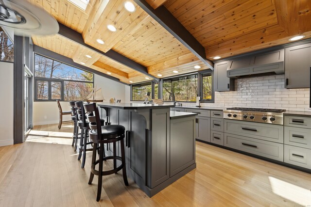 187 Sherbrook Dr, Goshen, CT 06756 - kitchen featuring wood ceiling, a breakfast bar area, gray cabinetry, light wood finished floors, and stainless steel gas cooktop