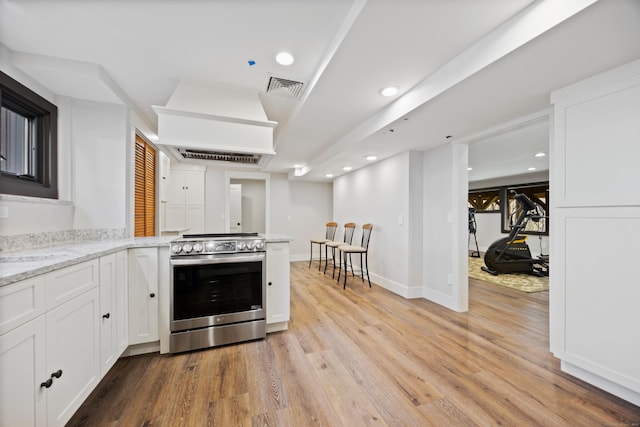 187 Sherbrook Dr, Goshen, CT 06756 - kitchen with recessed lighting, stainless steel electric range, visible vents, light wood-style flooring, and white cabinetry