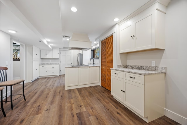 187 Sherbrook Dr, Goshen, CT 06756 - kitchen featuring a sink, custom range hood, white cabinetry, and wood finished floors