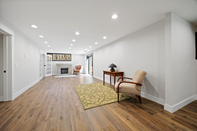 187 Sherbrook Dr, Goshen, CT 06756 - living area with a fireplace with raised hearth, recessed lighting, wood finished floors, and baseboards