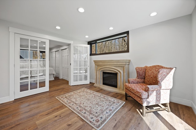 187 Sherbrook Dr, Goshen, CT 06756 - sitting room featuring a glass covered fireplace, wood finished floors, recessed lighting, and baseboards