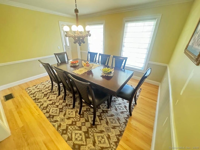 598 Nichols Ave, Stratford, CT 06614 - dining space featuring an inviting chandelier, baseboards, wood finished floors, and visible vents