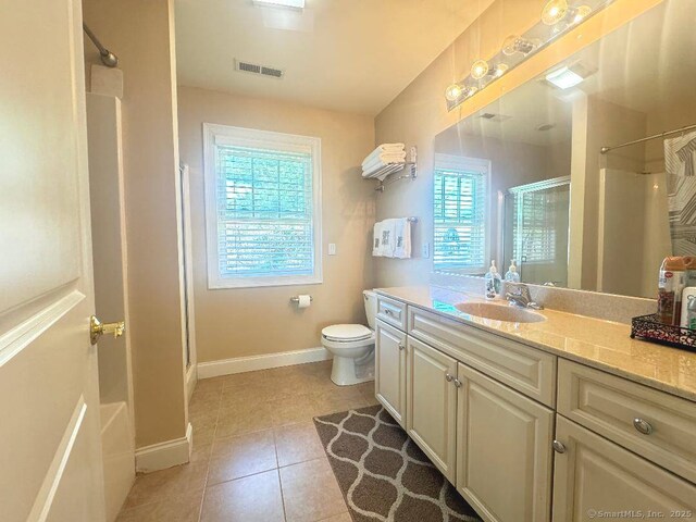 598 Nichols Ave, Stratford, CT 06614 - full bath with tile patterned flooring, vanity, toilet, baseboards, and a stall shower