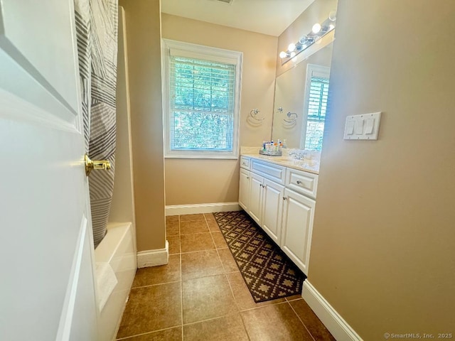 598 Nichols Ave, Stratford, CT 06614 - full bath with walk in shower, tile patterned flooring, vanity, baseboards, and a tub to relax in