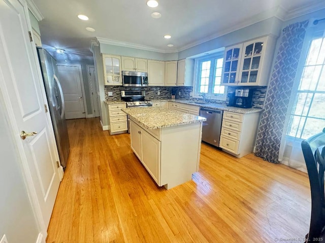 598 Nichols Ave, Stratford, CT 06614 - kitchen featuring a sink, crown molding, a center island, and appliances with stainless steel finishes