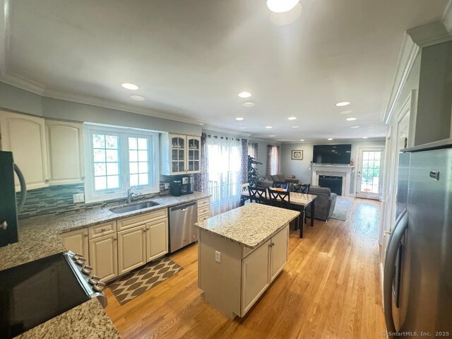598 Nichols Ave, Stratford, CT 06614 - kitchen featuring a healthy amount of sunlight, stainless steel appliances, a sink, and a kitchen island