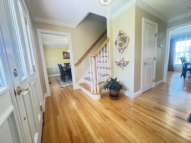 598 Nichols Ave, Stratford, CT 06614 - entryway featuring stairway, light wood finished floors, crown molding, and baseboards