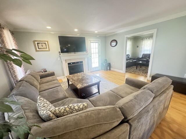 598 Nichols Ave, Stratford, CT 06614 - living area featuring a fireplace, wood finished floors, baseboards, ornamental molding, and recessed lighting