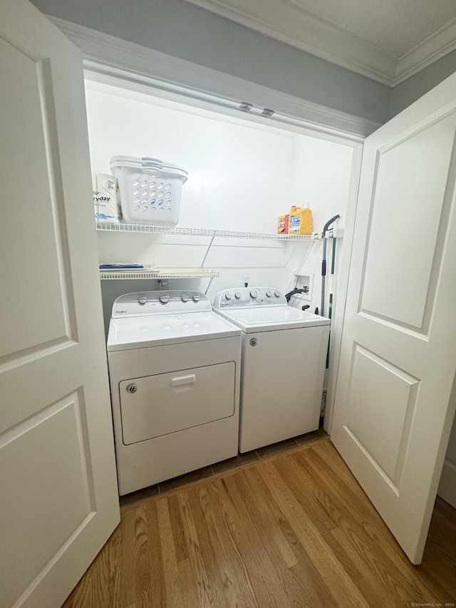 598 Nichols Ave, Stratford, CT 06614 - washroom featuring ornamental molding, laundry area, washing machine and dryer, and light wood-style flooring