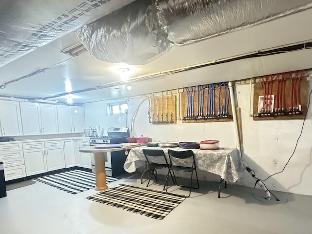 598 Nichols Ave, Stratford, CT 06614 - kitchen featuring white cabinets, concrete floors, and stainless steel gas stove