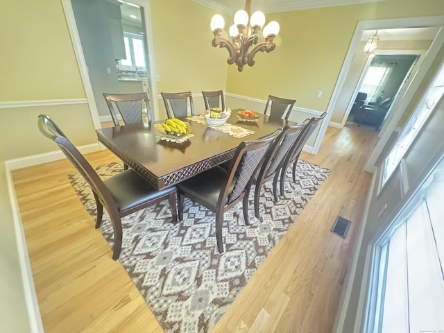 598 Nichols Ave, Stratford, CT 06614 - dining area with baseboards, a notable chandelier, light wood finished floors, and visible vents