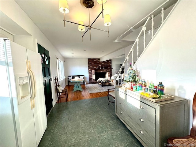 35 Marjorie Dr, North Branford, CT 06471 - kitchen featuring white refrigerator with ice dispenser, a chandelier, and a fireplace