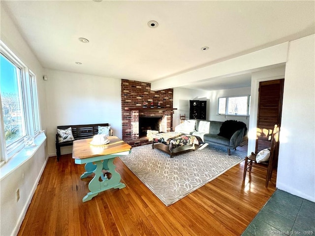 35 Marjorie Dr, North Branford, CT 06471 - living area featuring a brick fireplace, wood finished floors, and baseboards