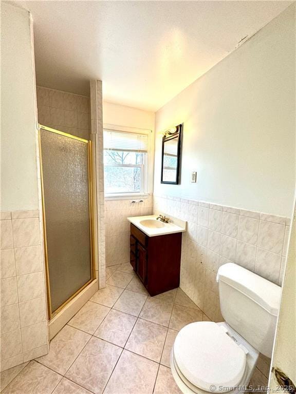 35 Marjorie Dr, North Branford, CT 06471 - full bathroom featuring tile walls, vanity, tile patterned floors, a stall shower, and a wainscoted wall