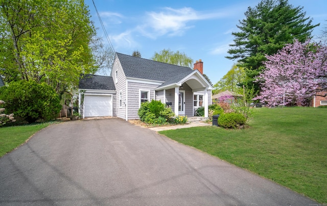 22 Hooker Dr, West Hartford, CT 06107 - view of front of house featuring a front yard, roof with shingles, a chimney, an attached garage, and driveway