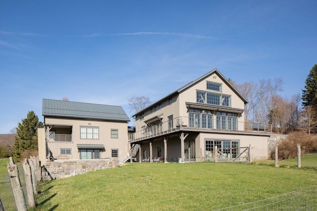 back of house featuring a lawn, a deck, and stairway