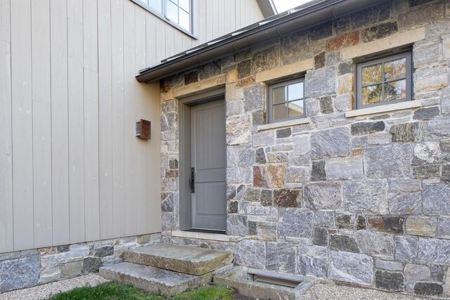property entrance with stone siding