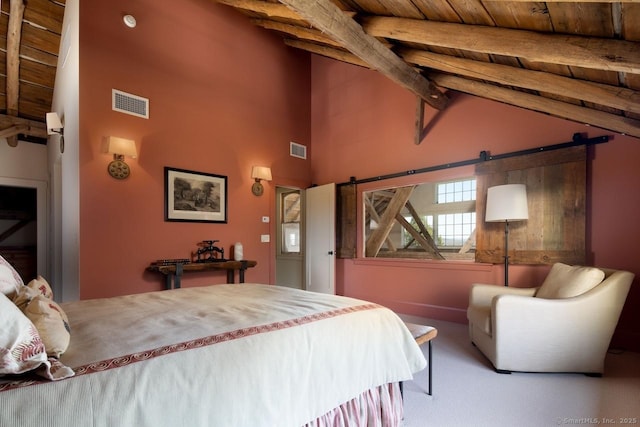 carpeted bedroom with visible vents, a barn door, beam ceiling, and high vaulted ceiling