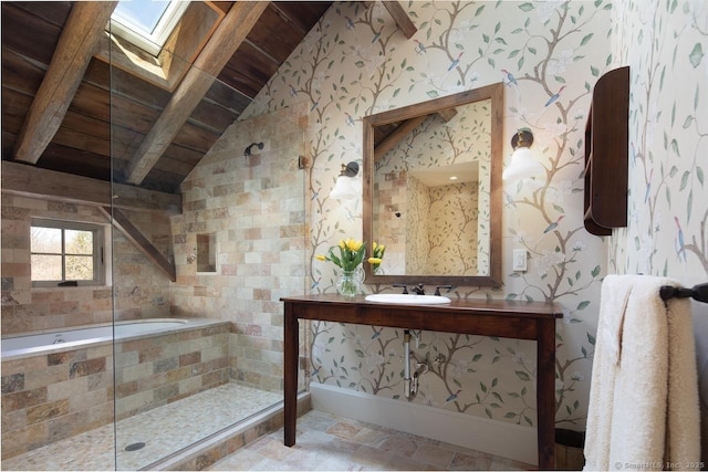 bathroom with wood ceiling, a sink, vaulted ceiling with skylight, wallpapered walls, and tiled shower