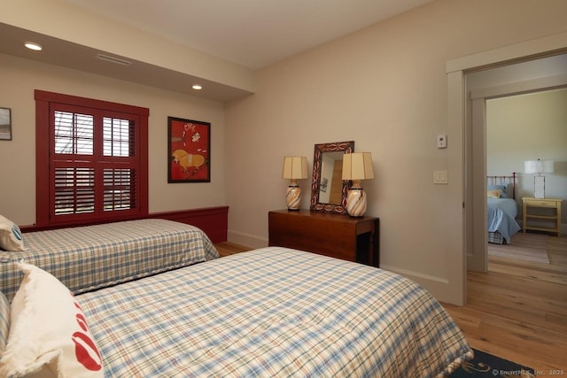bedroom with visible vents, recessed lighting, wood finished floors, and baseboards