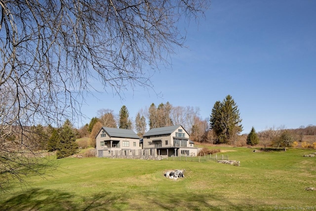 view of yard featuring a wooden deck and a fire pit