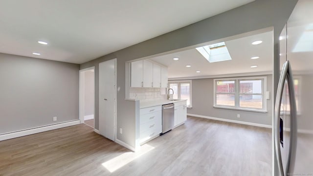 8 Batt St, Middletown, CT 06457 - kitchen featuring light wood-style flooring, a skylight, appliances with stainless steel finishes, and light countertops