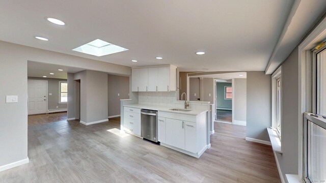 8 Batt St, Middletown, CT 06457 - kitchen featuring a sink, tasteful backsplash, light countertops, stainless steel dishwasher, and a skylight