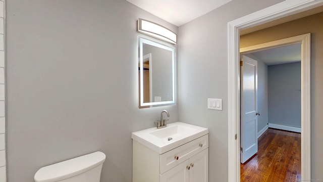 8 Batt St, Middletown, CT 06457 - bathroom with wood finished floors, a baseboard heating unit, toilet, and vanity