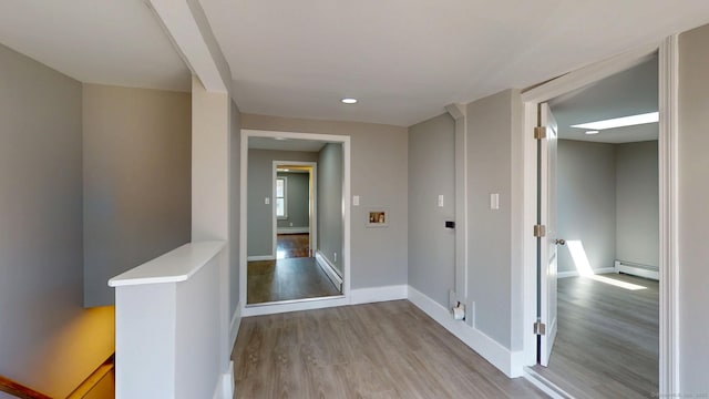8 Batt St, Middletown, CT 06457 - corridor with recessed lighting, baseboards, wood finished floors, and a baseboard radiator