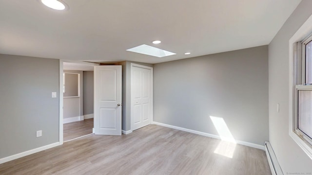8 Batt St, Middletown, CT 06457 - interior space featuring a baseboard heating unit, recessed lighting, baseboards, and light wood-style floors