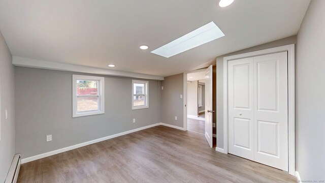 8 Batt St, Middletown, CT 06457 - interior space with a baseboard heating unit, recessed lighting, a skylight, and wood finished floors