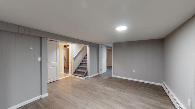 8 Batt St, Middletown, CT 06457 - finished below grade area featuring light wood-type flooring, baseboards, stairway, and a baseboard radiator