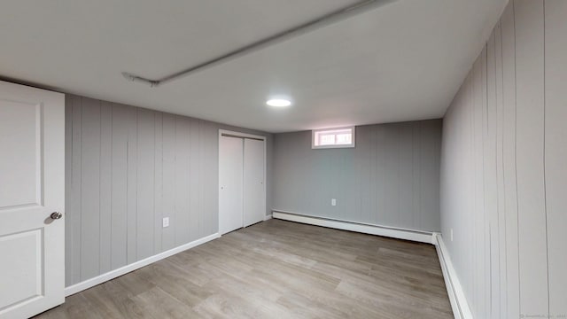 8 Batt St, Middletown, CT 06457 - below grade area featuring a baseboard heating unit, baseboard heating, and light wood-type flooring