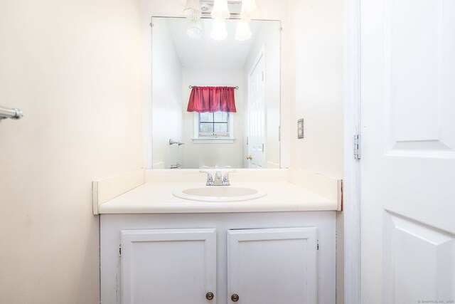 bathroom featuring an inviting chandelier and vanity